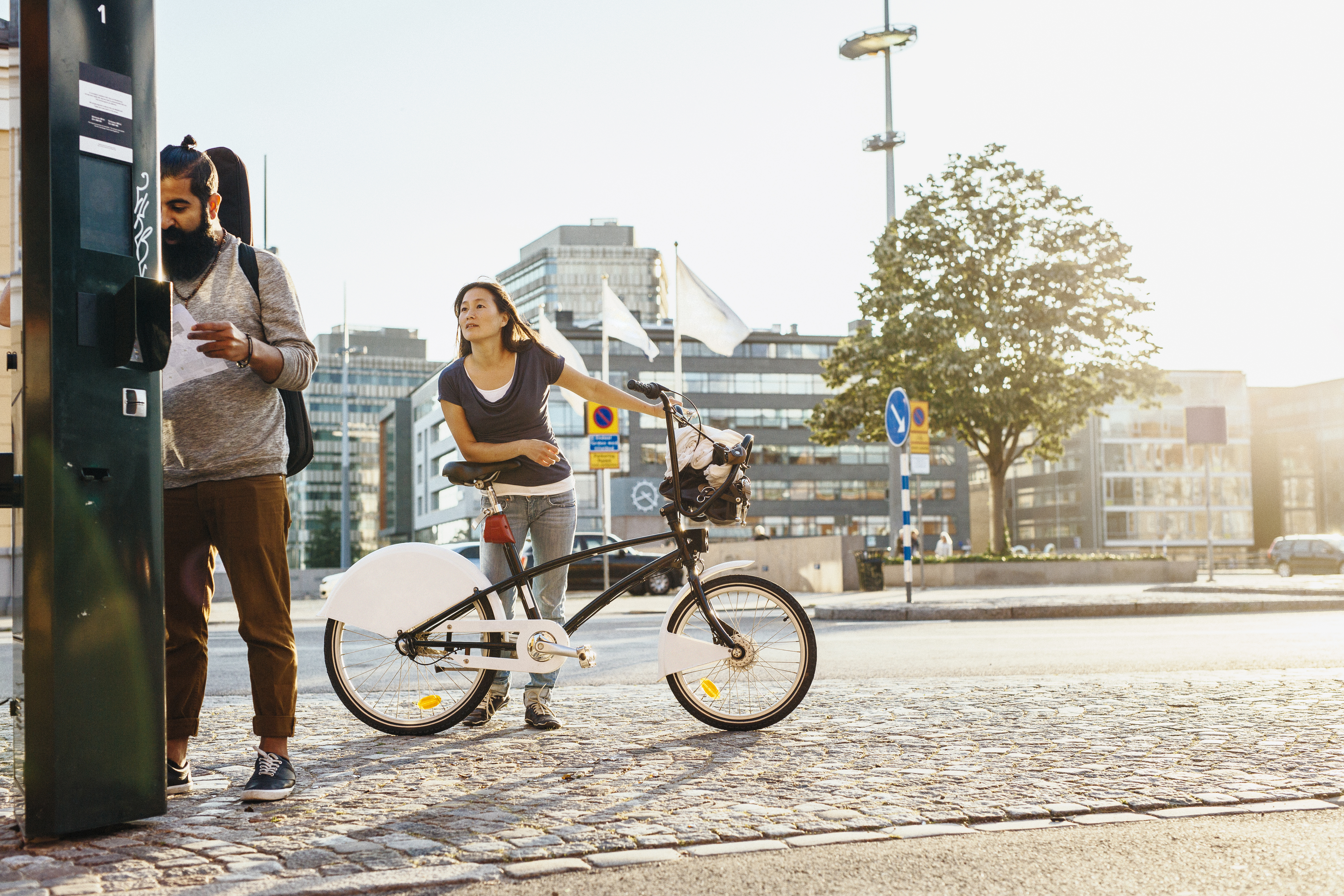 People renting bicycles at rental station